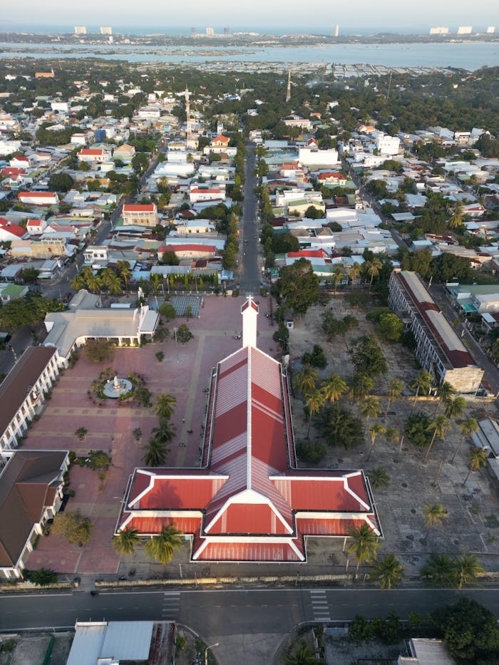 A stunning aerial view of Khánh Hòa City, Vietnam featuring a prominent building and surrounding landscape.